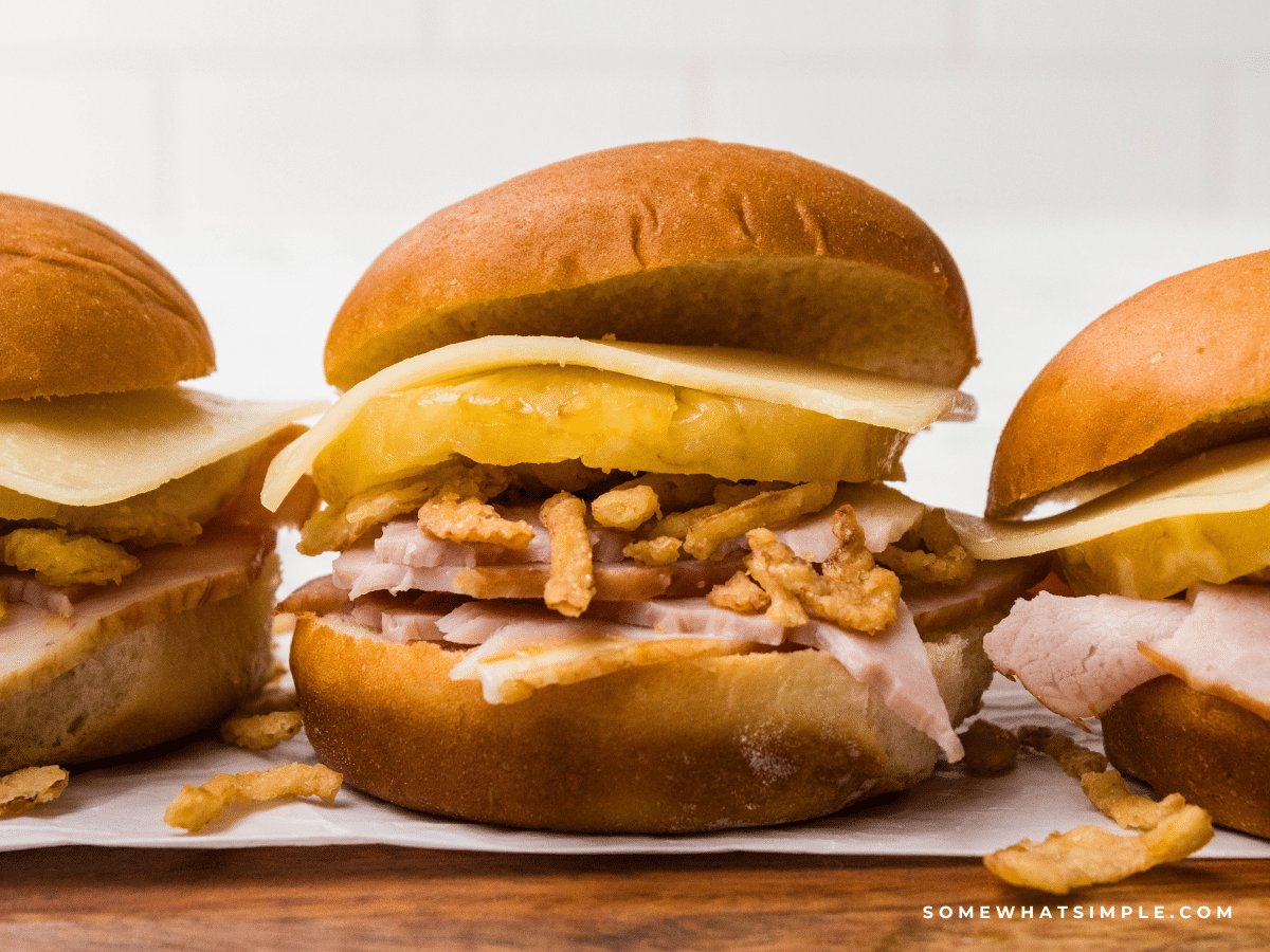 close up of 3 Hawaiian Ham Sandwiches in a straight line