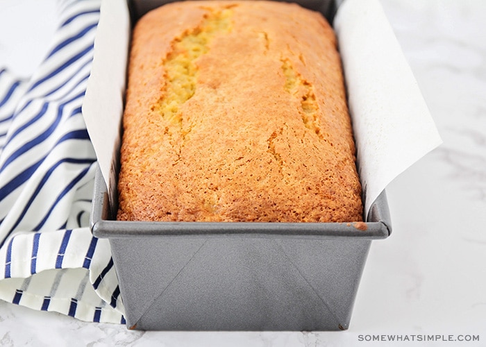 a freshly baked loaf of banana bread in a metal bread pan