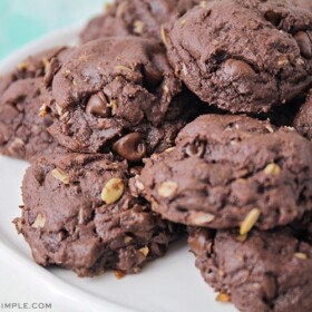 a pile of devils food cake mix cookies on a white cake stand