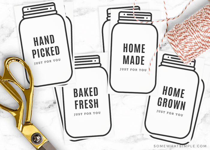 gift tags in the shape of mason jars cut out from this free printable and laid on the counter