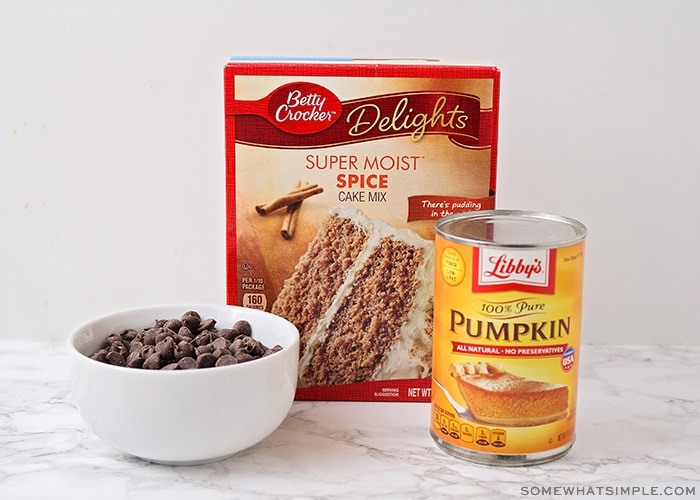 a box of betty crocker super moist spice cake, a bowl of chocolate chips and a can of pumpkin sitting on a counter
