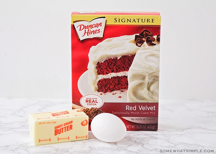 a box of Duncan Hines red velvet cake mix, an egg and a stick of butter on a counter