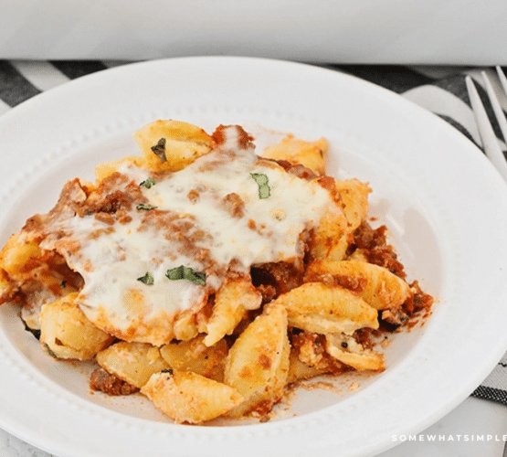 unstuffed shells being served on a white plate