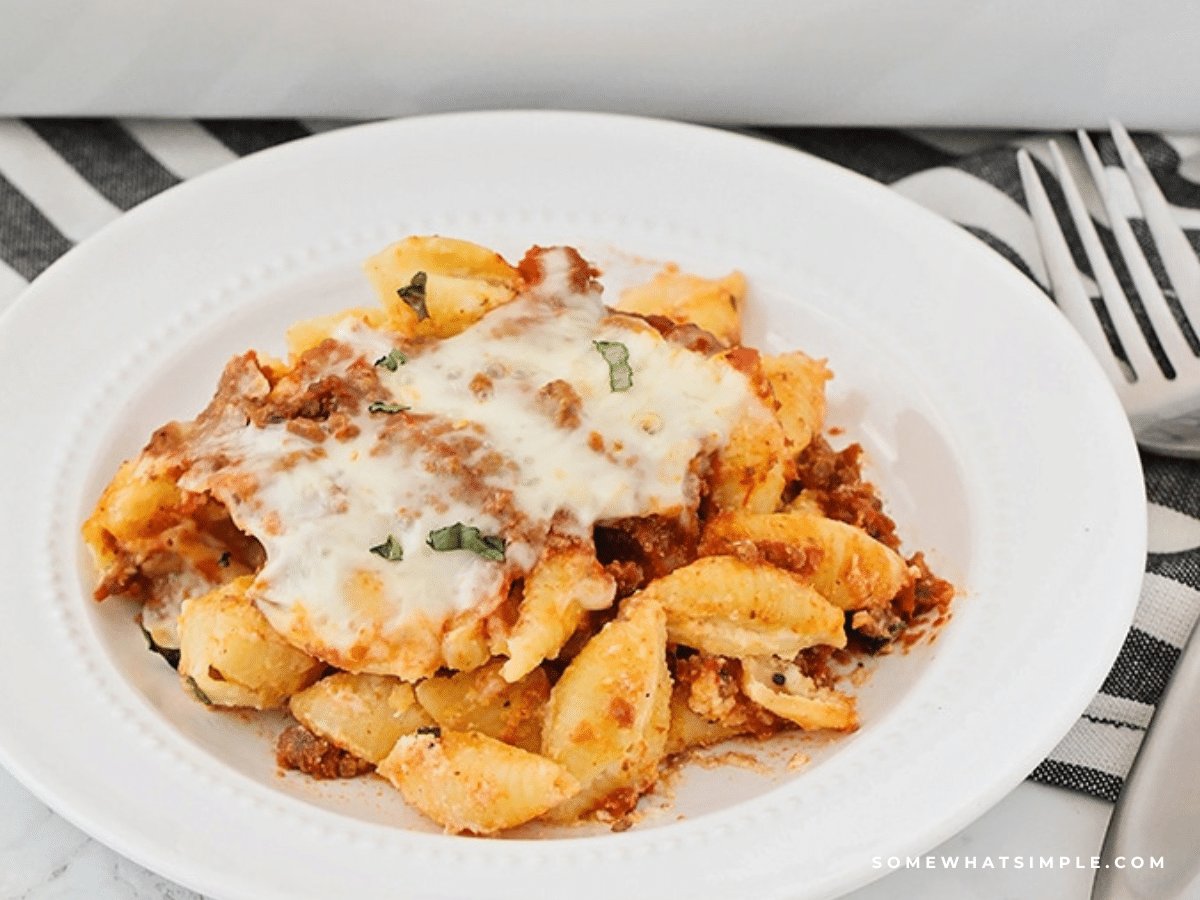 unstuffed shells being served on a white plate