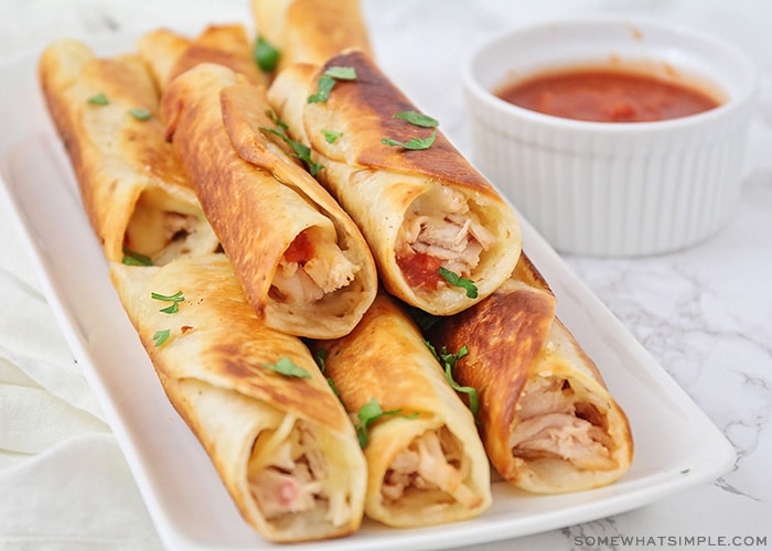 a stack of freshly fried homemade Chicken Taquitos