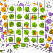 colorful Halloween bingo cards with candy corns being used as a game piece