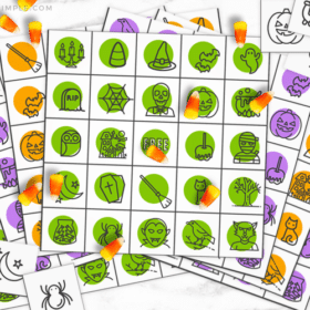 colorful Halloween bingo cards with candy corns being used as a game piece