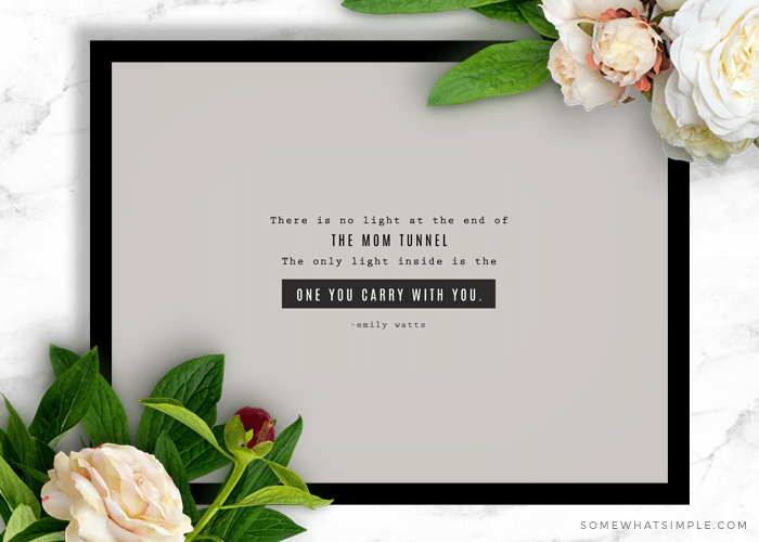 motherhood quote in black frame with peach flowers