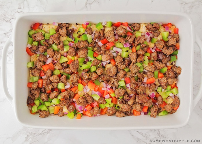 looking down on a casserole pan filled with sausage vegetables and tater tots