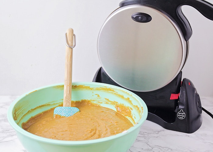 waffle batter next to a Belgian waffle maker