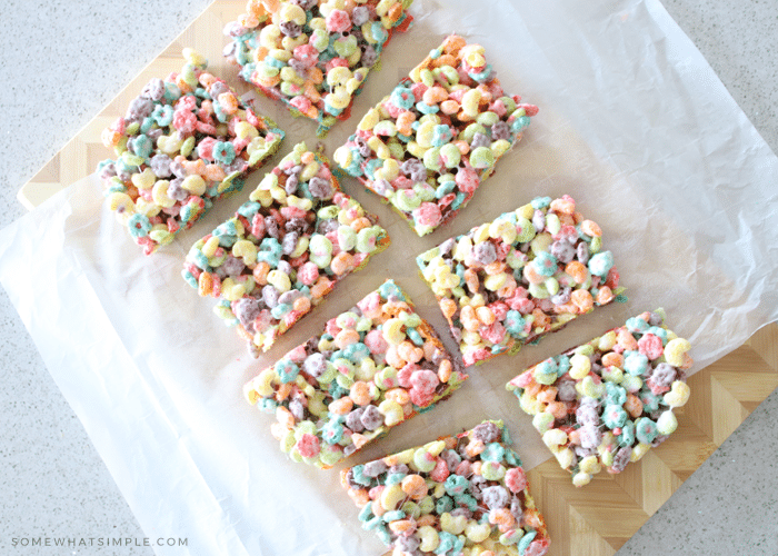 squares of rice krispie treats laying on parchment paper