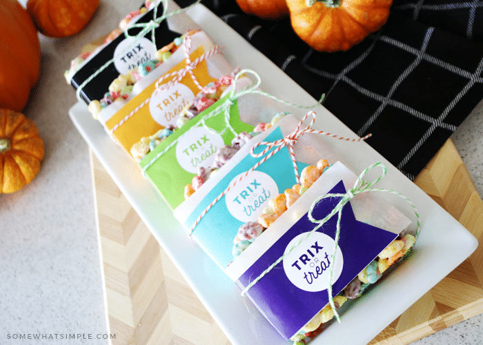 a serving tray filled with rice krispie treats with gift tags attached