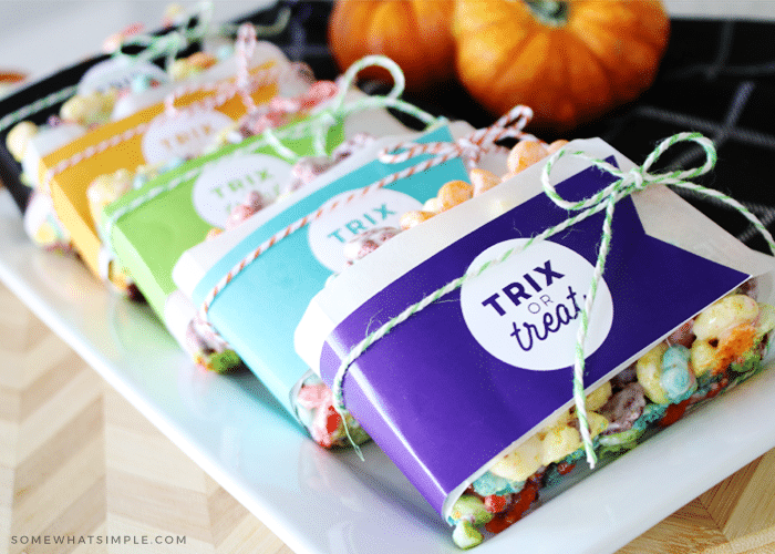 Trix rice krispies treats wrapped in gift tags that say trix or treat