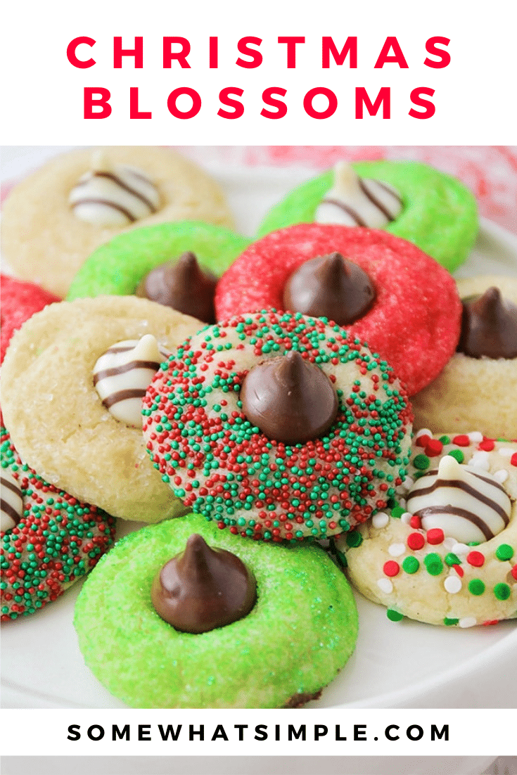 These Christmas blossom cookies are a fun and delicious way to spread some holiday cheer!  Made with your favorite sugar cookie dough, Christmas decorations and a Hershey's Kiss, these cookies are irresistible! These are so easy, they take only minutes to prepare but look like you've been baking all day! via @somewhatsimple