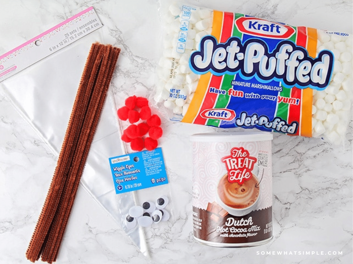 supplies needed to make reindeer hot cocoa bags laid out