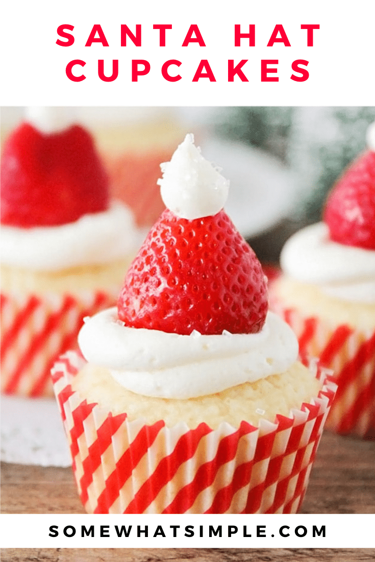 Santa hat cupcakes are a fun and festive dessert to serve during the Christmas holidays.  Topped with a fresh strawberry and homemade frosting, you won't be able to just eat one of these cupcakes. These are the perfect festive dessert idea to serve at your next Christmas party. via @somewhatsimple