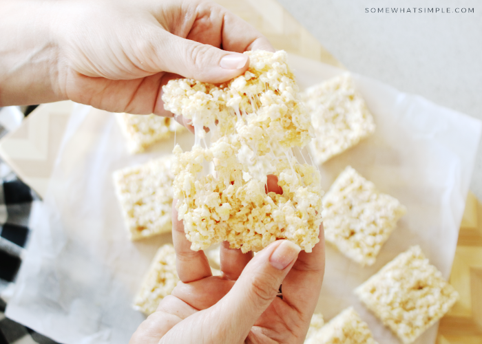 hands pulling apart a gooey Rice Krispie treat