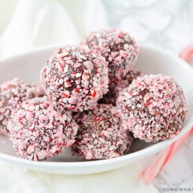 a bowl filled with protein truffles covered in candy canes