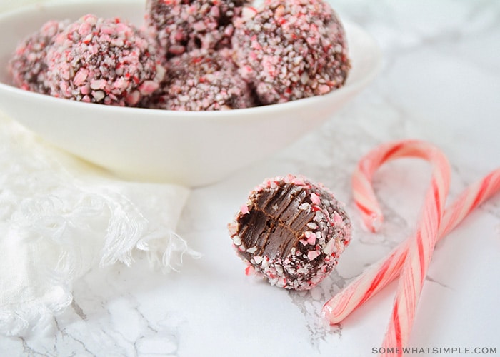 a bowl of protein truffles covered in crushed candy canes