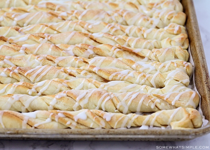 cinnamon bread twists with icing drizzled over the top