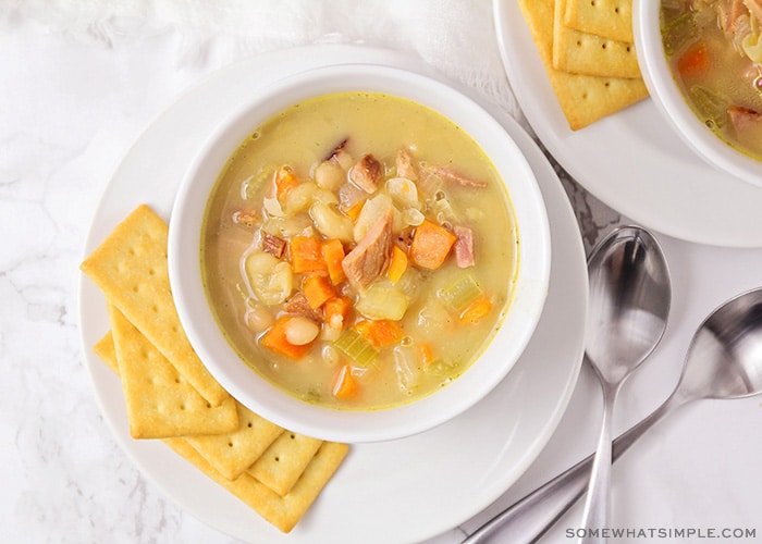 looking down on a bowl of vegetable and ham soup