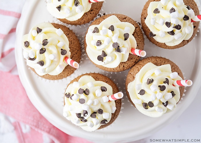 looking down on cupcakes topped with white frosting and chocolate chips