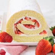 a strawberry shortcake roll on a serving platter