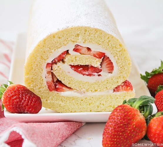a strawberry shortcake roll on a serving platter