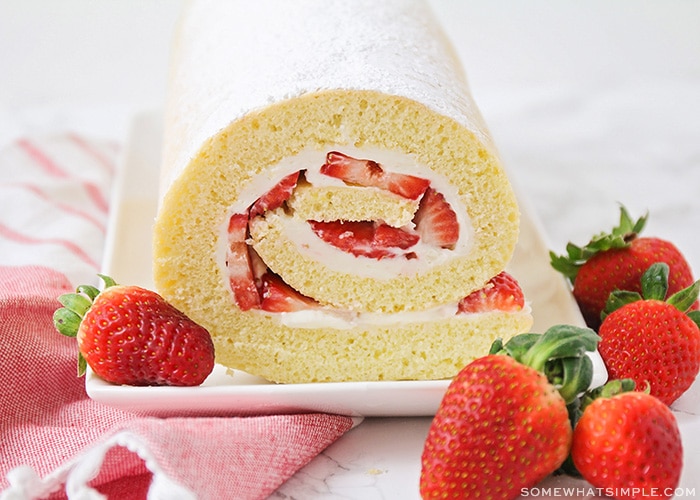 a strawberry shortcake roll on a serving platter