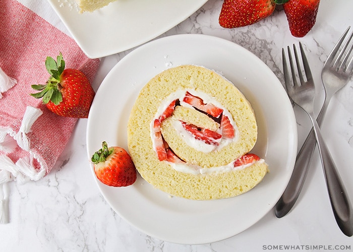 a slice of strawberry shortcake roll on a plate