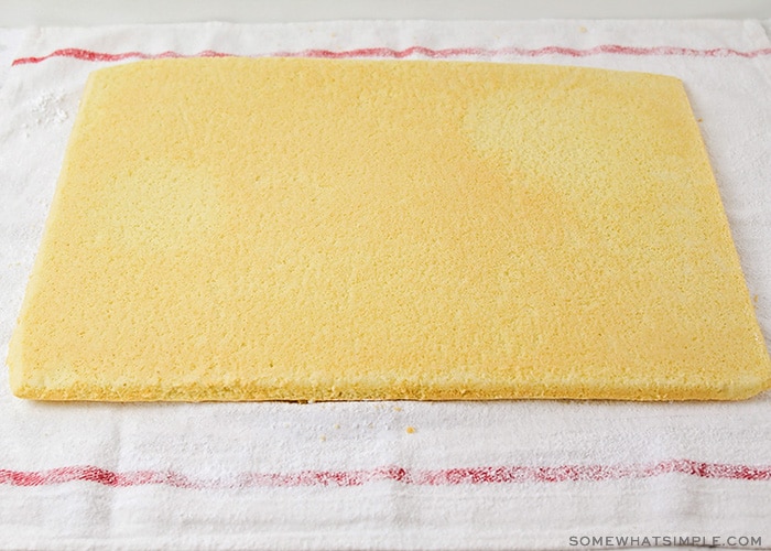 a thin rectangular cake laying on a towel