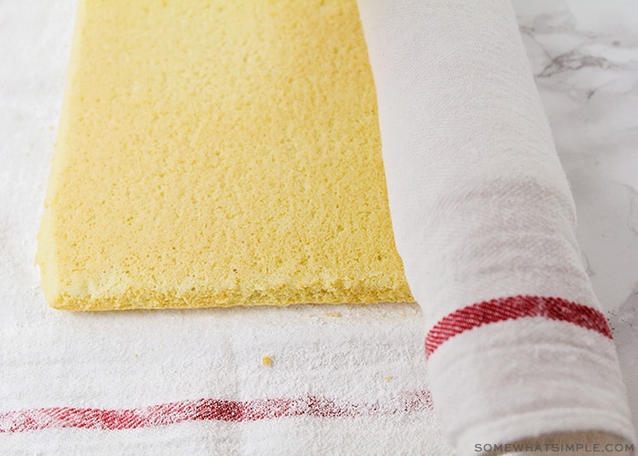 a sheet cake being rolled in a towel