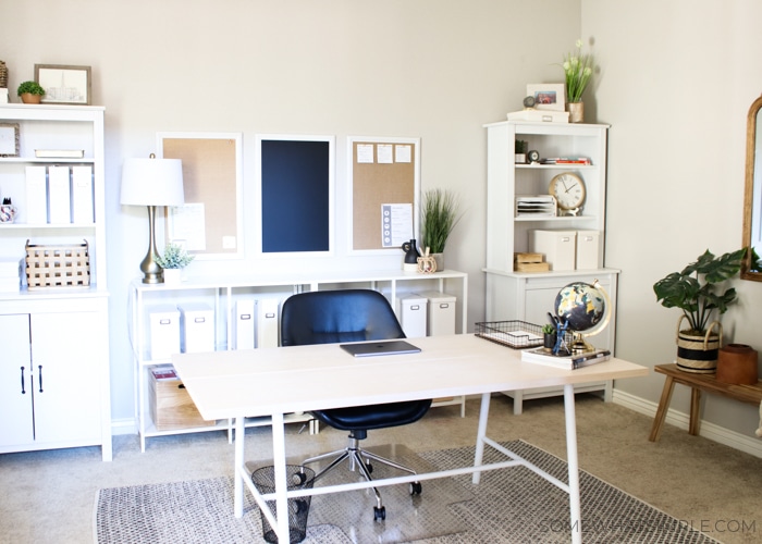 a home office with a desk and shelves