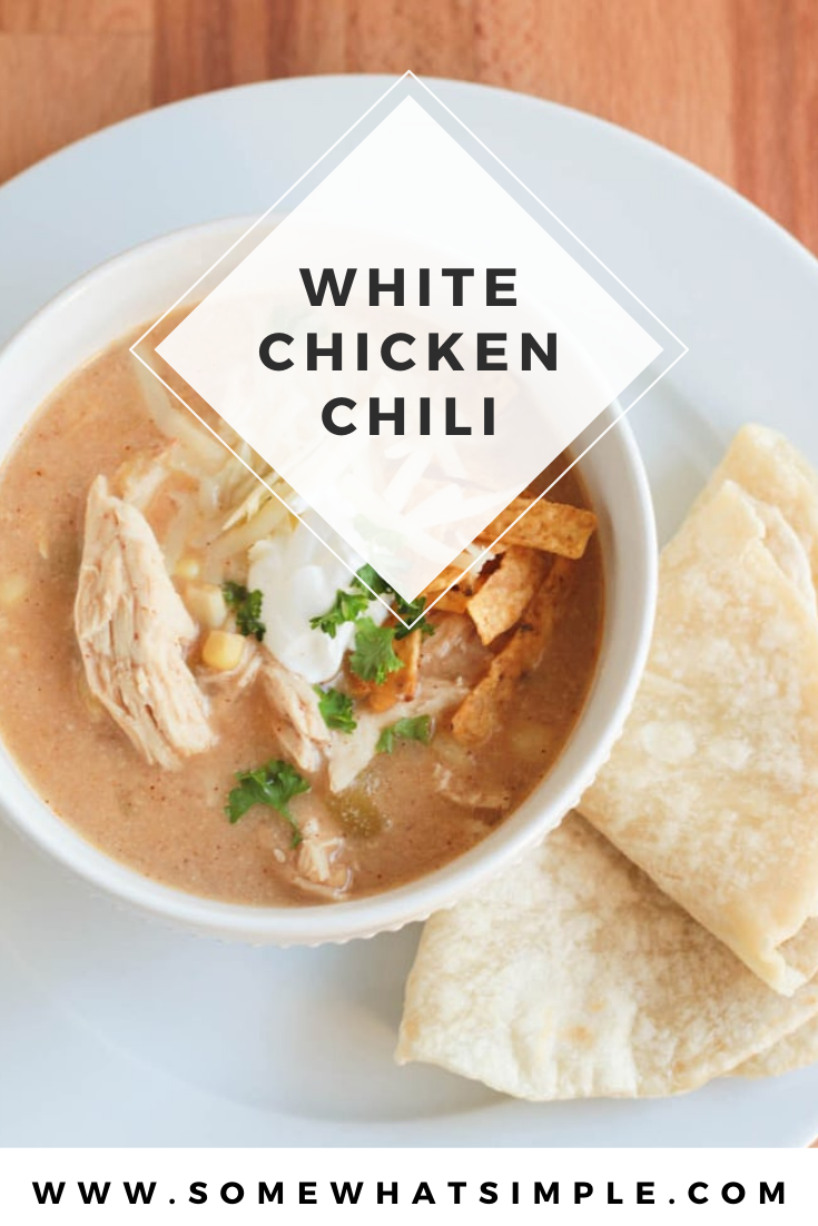 This slow cooker white chicken chili recipe is the perfect dinner on a chilly day.  Filled with tender chicken, white beans, vegetables and cream cheese, it doesn't get any better than this comfort food! via @somewhatsimple