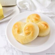 two heart shaped dinner rolls on a plate