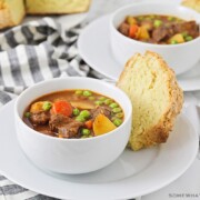 two bowls of Irish stew with a side of soda bread
