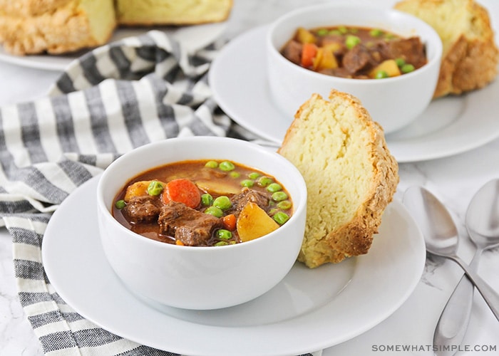 two bowls of Irish stew with a side of soda bread