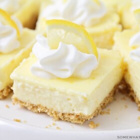 lemon cheesecake squares topped with whipped cream