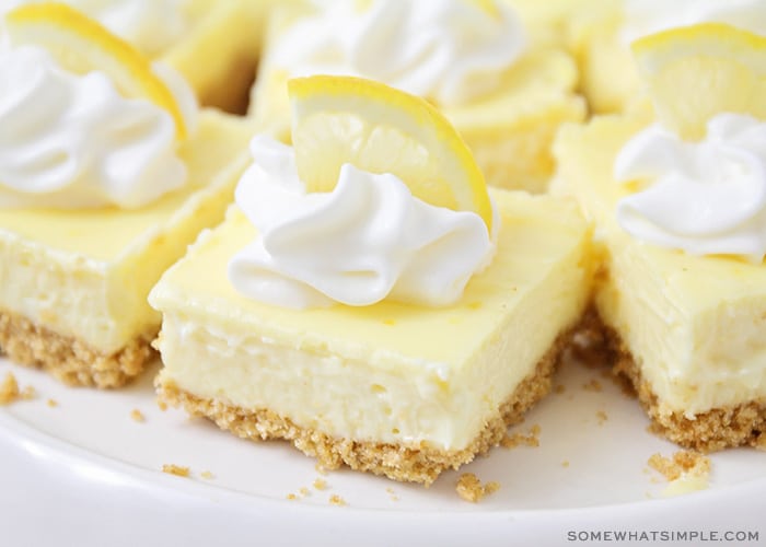 lemon cheesecake squares topped with whipped cream