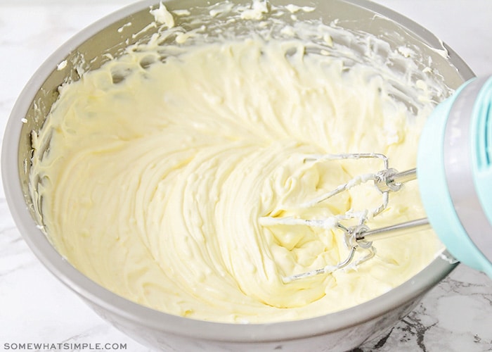 a cheesecake filling being whipped in a bowl