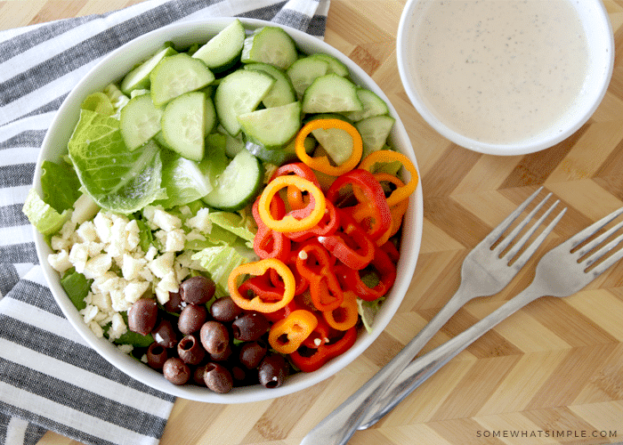 a garden salad with a side of homemade Italian dressing