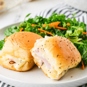 long image of Ham and Cheese Sliders plated with a garden salad