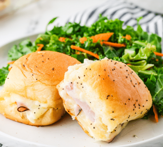 long image of Ham and Cheese Sliders plated with a garden salad