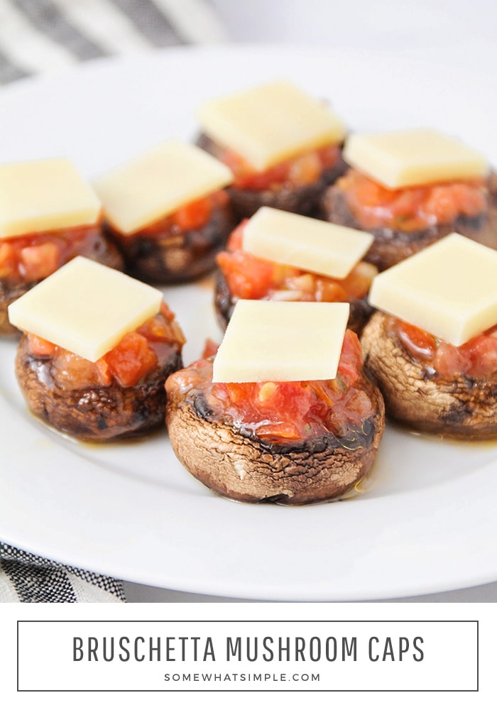 These bruschetta stuffed mushrooms are a tasty, healthier option for your next celebration or gathering.  Now you can enjoy a classic party bruschetta without all of the carbs.  #bruschetta #stuffedmushrooms #ketomushroomcaps #stuffedportobellomushrooms #easyappetizer via @somewhatsimple