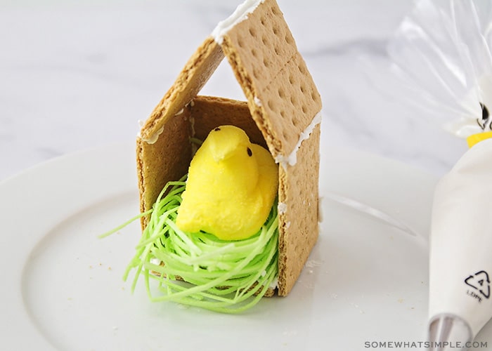 a peep candy inside a graham cracker birdhouse