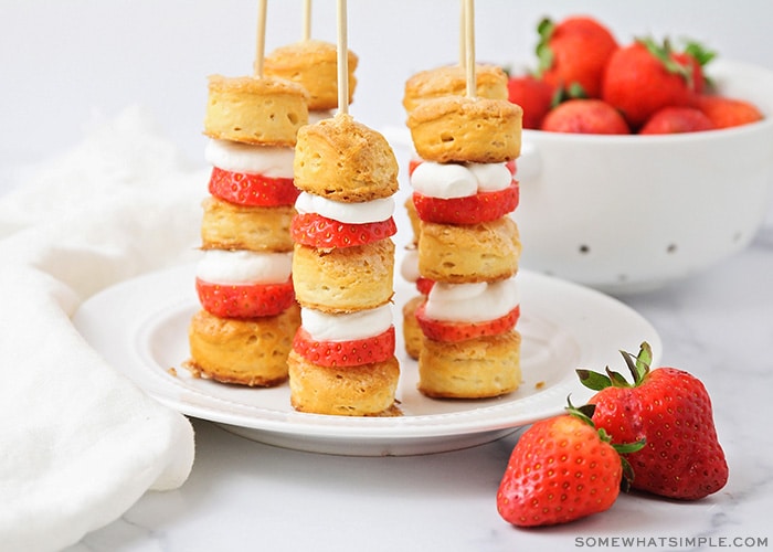 a plate of strawberry shortcake kabobs