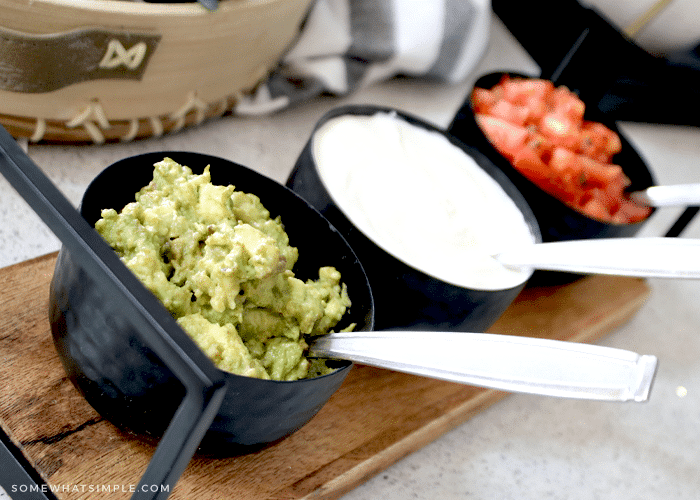 small bowls of guacamole, sour cream and salsa