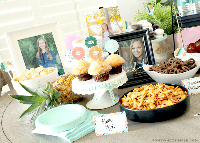 A table with treats and finger foods for a graduation party