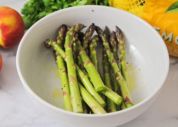 trimmed asparagus in a white bowl