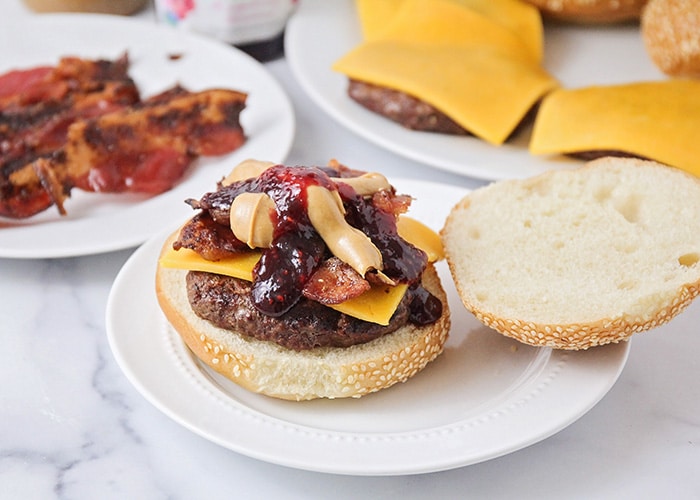 These peanut butter and jelly bacon cheeseburgers are over-the-top delicious, and so easy to make! They're a fun twist on a basic burger! 